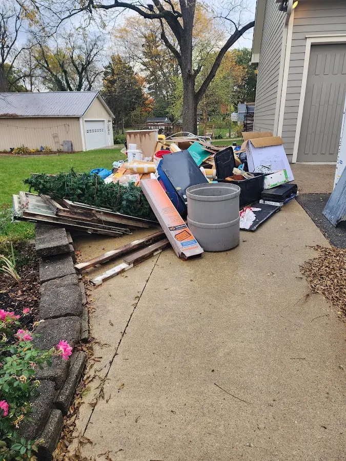 Dumpster being loaded with debris for Demolition Dumpster Rental in Lincoln Park